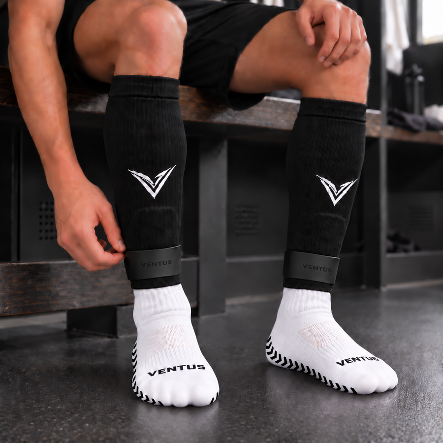 Player in the changing room wearing the full Ventus system: black Pro-Cut Sleeves, SockLock straps and white Pro-Grip Socks