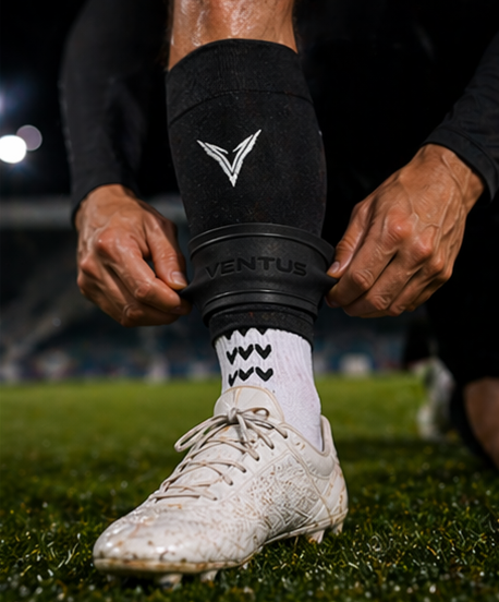 Player pulling a Black Pro-Cut Sleeve over a grip sock, with SockLock fitted