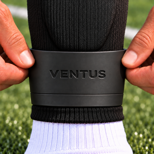 Player fitting a black Ventus SockLock strap over a Pro-Cut Sleeve at the ankle