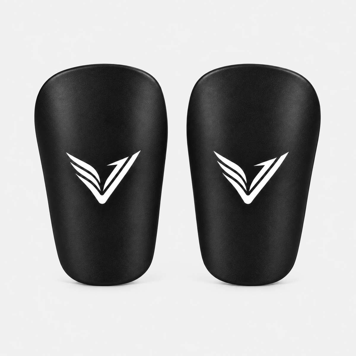 Pair of Stealth Guards mini shin guards in black with the Ventus V, front view