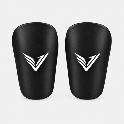 Pair of Stealth Guards mini shin guards in black with the Ventus V, front view