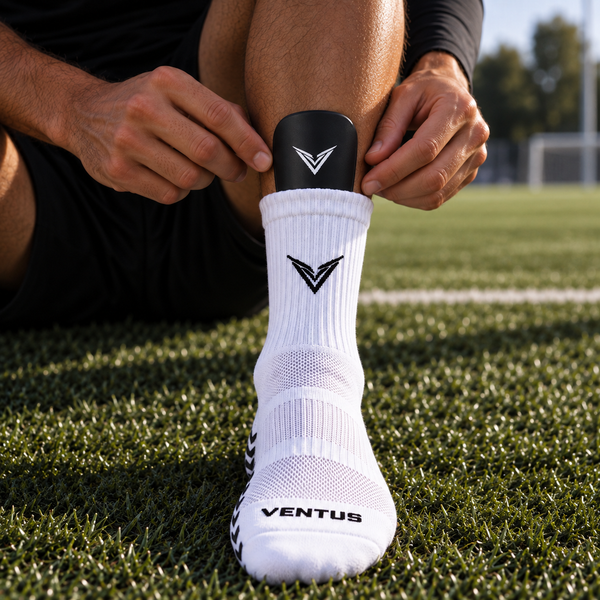 Player sliding a Stealth Guard into a grip sock before a match